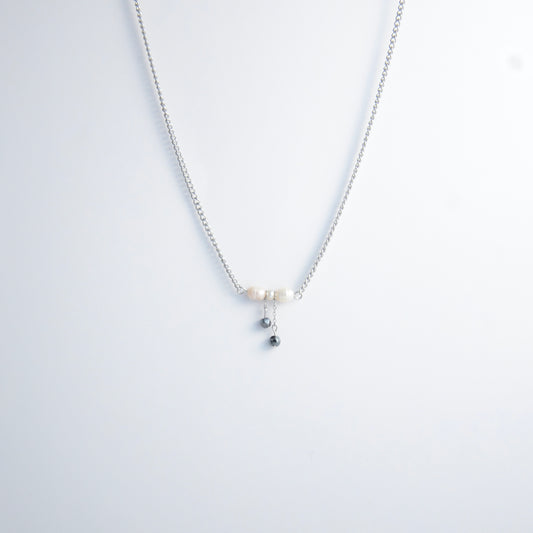 Silver necklace with a bow made of pearls and glass beads