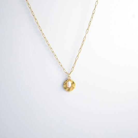 Gold paperclip necklace non-tarnish with a round sun pendant and a pearl on a light gray background