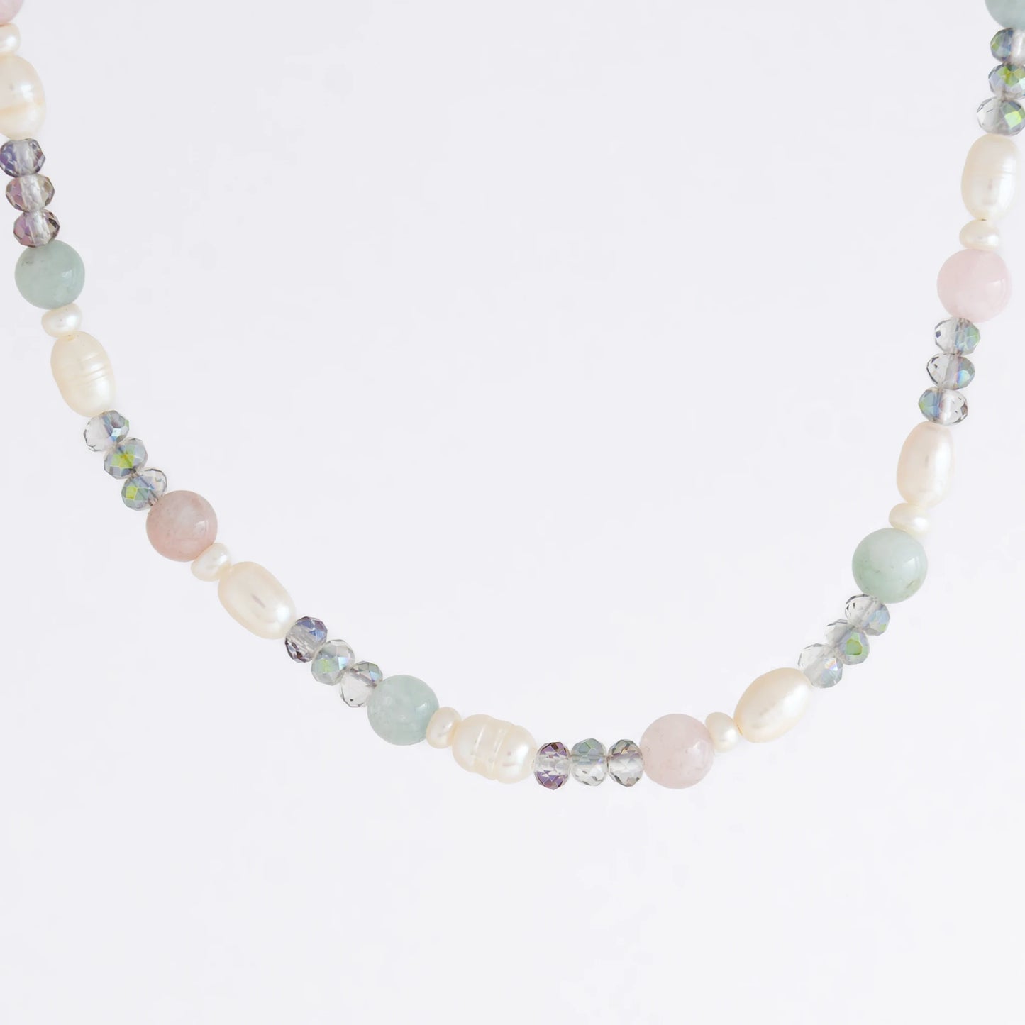 Beaded necklace with pearls and glass beads on a light gray background