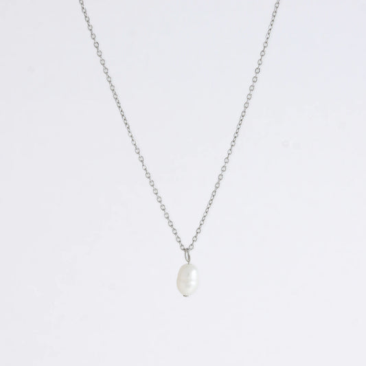 Silver dainty pearl necklace with freshwater pearl charm on a light gray background