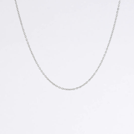 Silver stainless steel dainty chain necklace on a light gray background