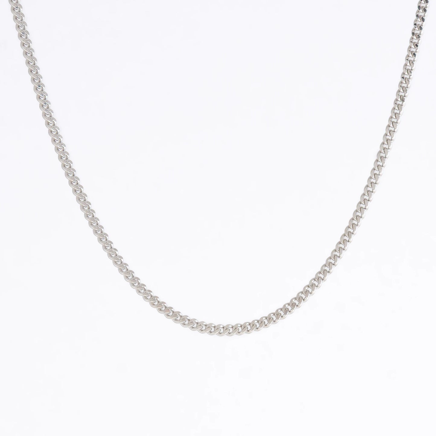 Curb chain necklace on a light gray background