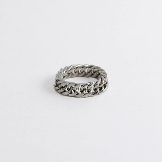 Silver braided cuban chain stainless steel ring on a white background