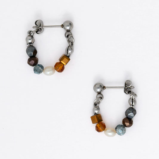 Pair of stainless steel beaded hoop earrings on a white background