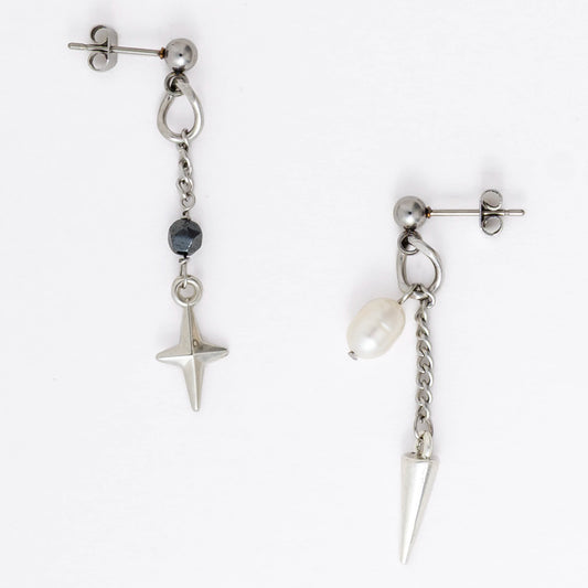 Pair of silver stainless steel ball stud drop earrings with a chain and star charm and a pearl and spike charm on a white background