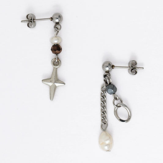 Pair of silver stainless steel ball stud drop earrings with orange and black glass beads and star and pearl charm with unique designs on a white background