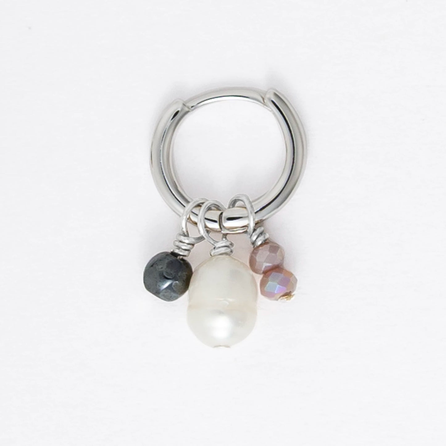 Pair of silver hoop earrings with pearls and a black bead on a white background
