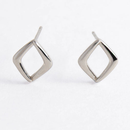 Pair of silver square earrings on a light gray background