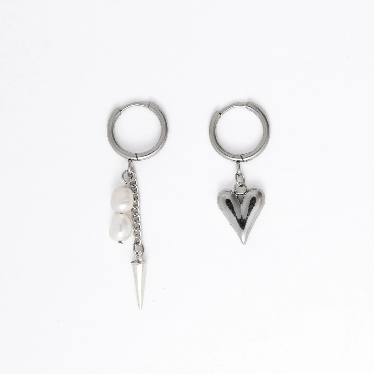 Pair of silver hoop earrings with unique designs on a white background
