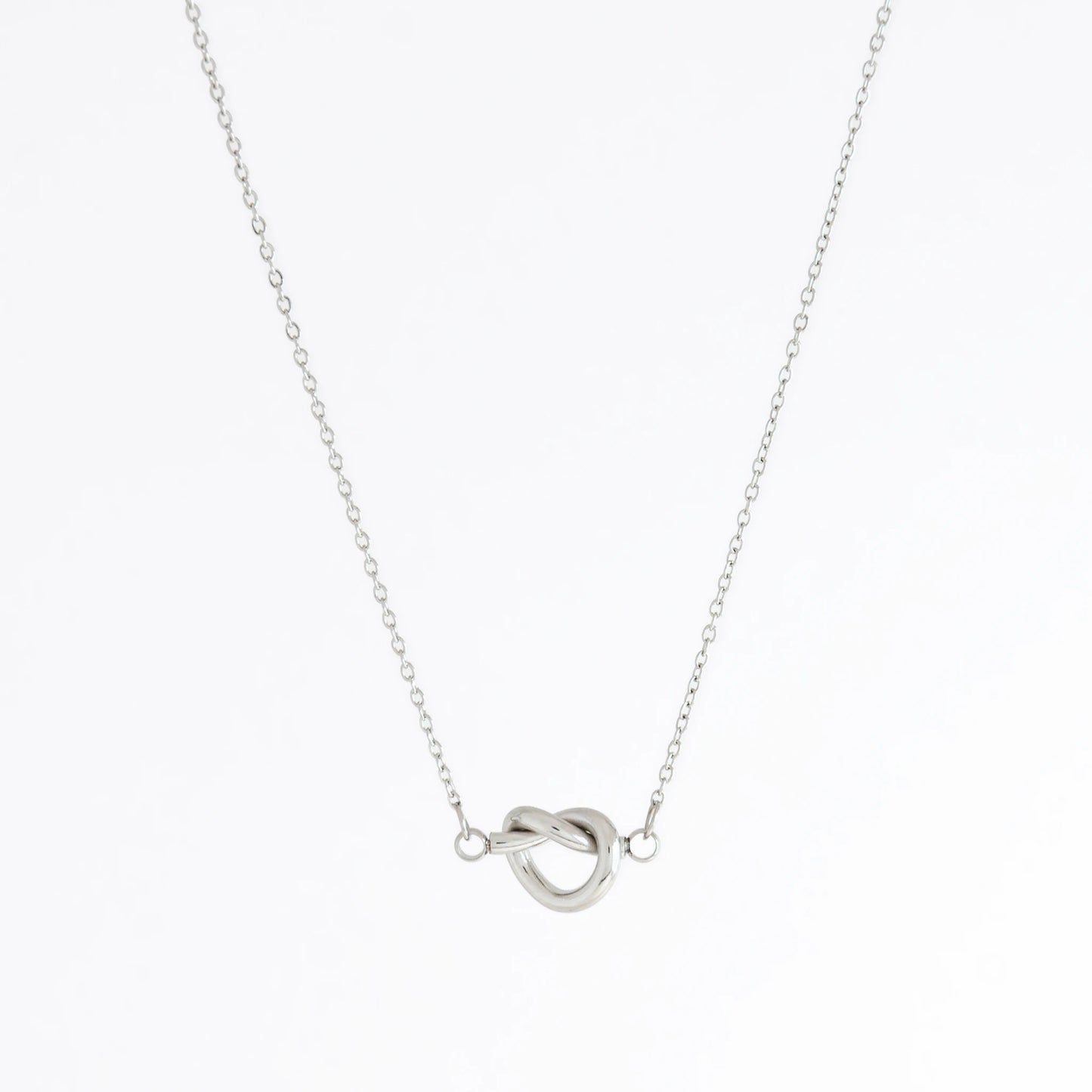 Silver necklace with a unique clasp design on a white background