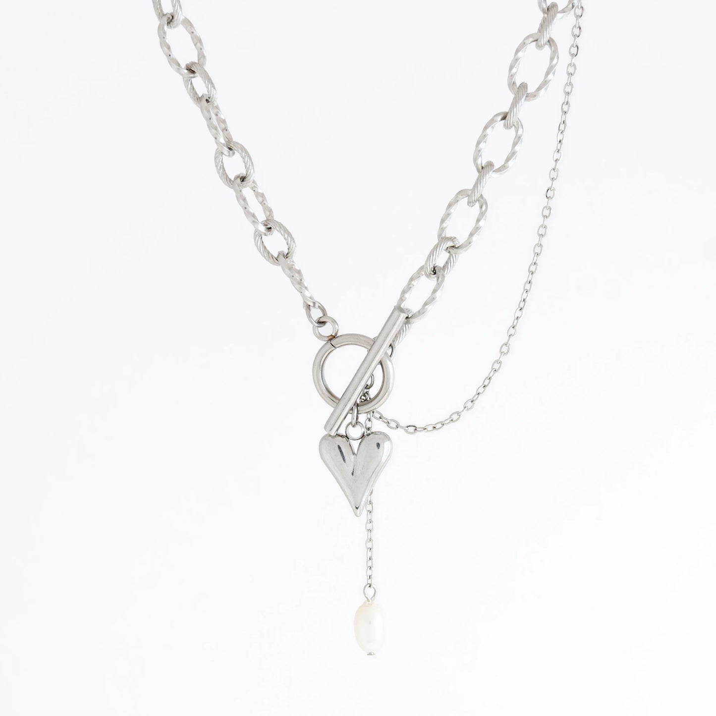 Silver paperclip necklace with heart and pearl pendant on a white background