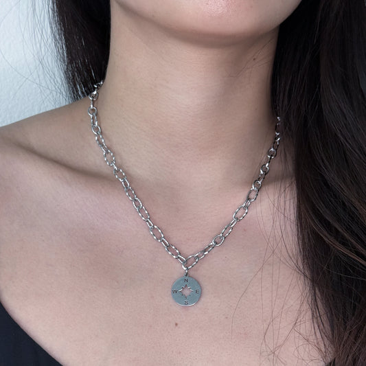 Silver chunky paperclip chain with a compass pendant worn by a model