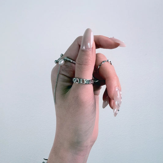 Sterling silver roman numeral ring on a gray background