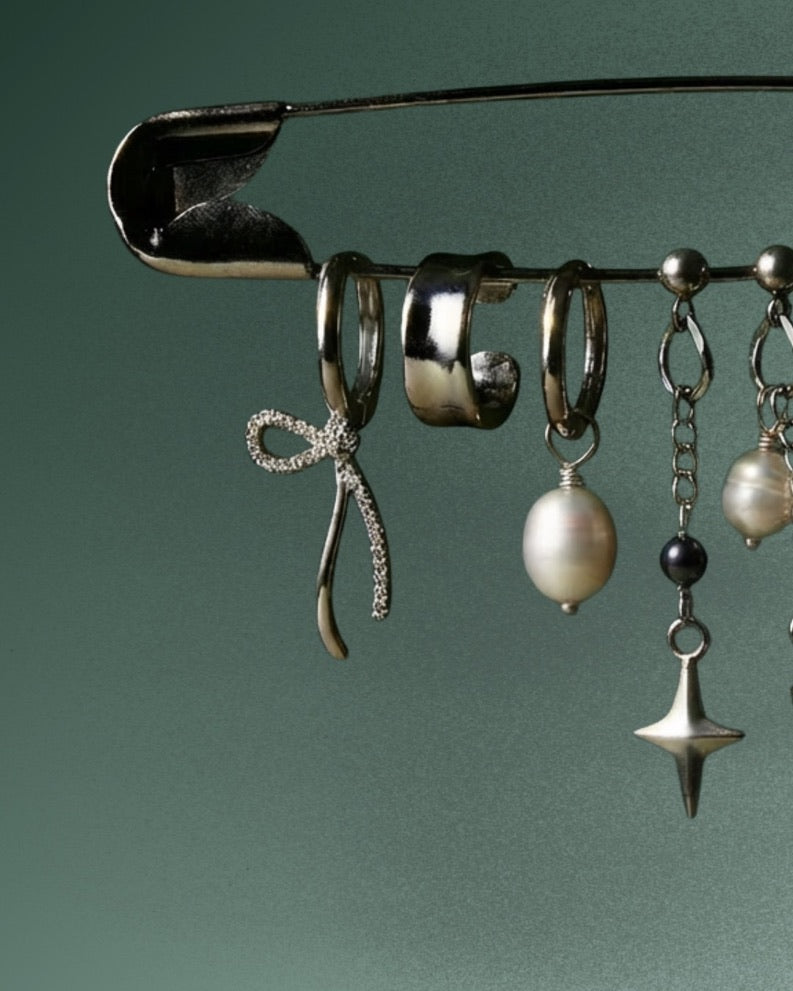 Freshwater pearl necklace draped against dark fabric, soft editorial mood - Glass Balloon