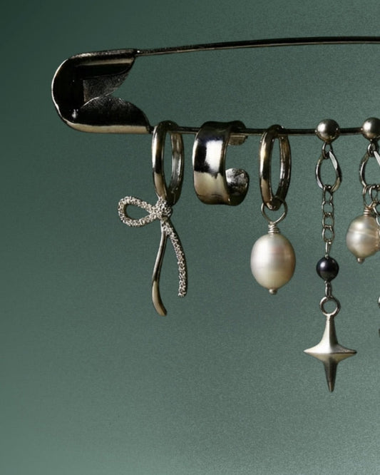 Freshwater pearl necklace draped against dark fabric, soft editorial mood - Glass Balloon