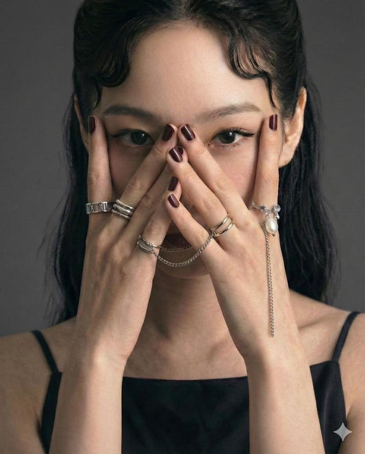 Sterling silver stacking rings on finger, textured bands in deliberate composition - Glass Balloon