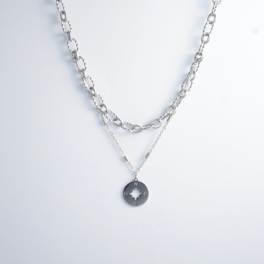 Silver layered paperclip necklaces non-tarnish with compass charm on a light gray background