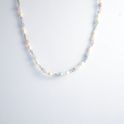Beaded necklace with pearls and glass beads on a light gray background