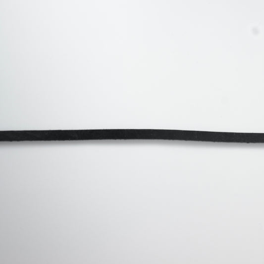 Black leather choker necklace on a light gray background