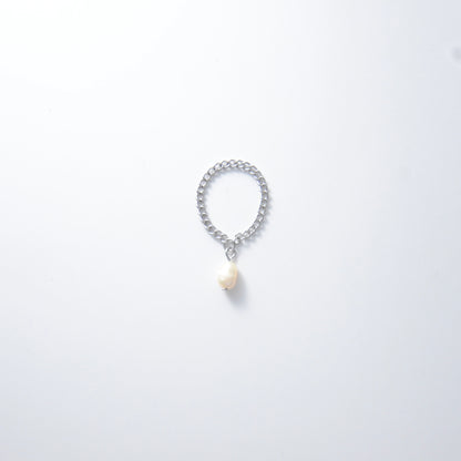 Silver stainless steel curb chain ring with a pearl charm on a white background