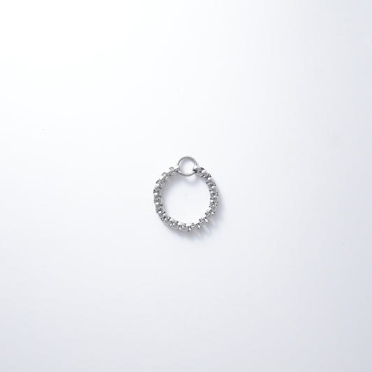 Silver stainless steel box chain ring on a light gray background non-tarnish geometric shape