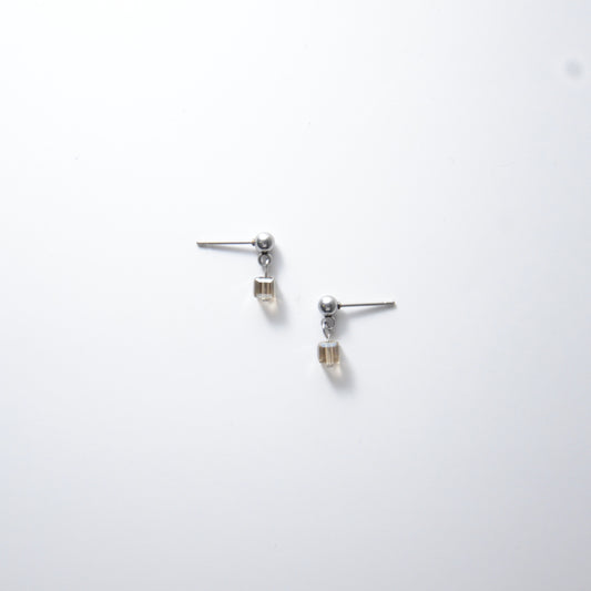 Pair of silver stainless steel ball stud earrings with sugar cube gray glass beads on a white background