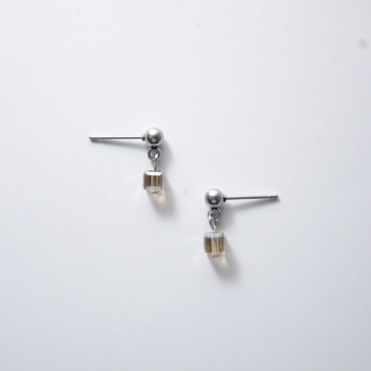 Pair of silver stainless steel ball stud earrings with sugar cube gray glass beads on a white background