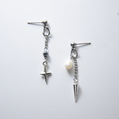Pair of silver stainless steel ball stud drop earrings with a chain and star charm and a pearl and spike charm on a white background