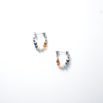 Pair of stainless steel beaded hoop earrings on a white background