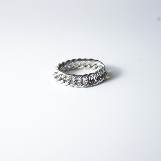 Silver braided cuban chain stainless steel ring on a white background