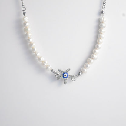 Silver stainless steel pearl choker necklace with a silver star evil eye pendant on a light gray background