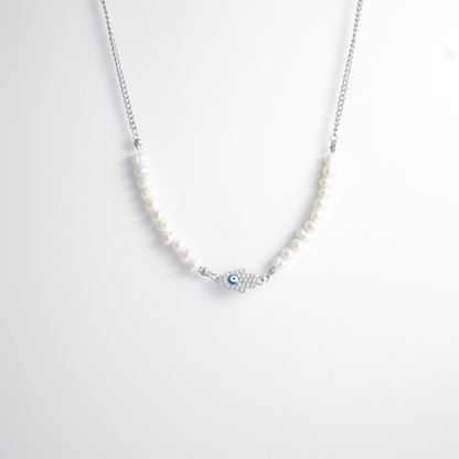 Silver stainless steel pearl choker necklace with a silver hand evil eye pendant on a light gray background