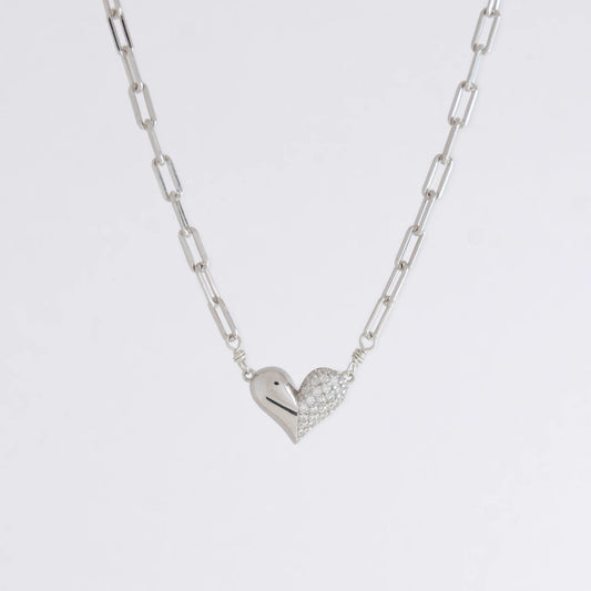 Silver heart-shaped pendant necklace on a light gray background