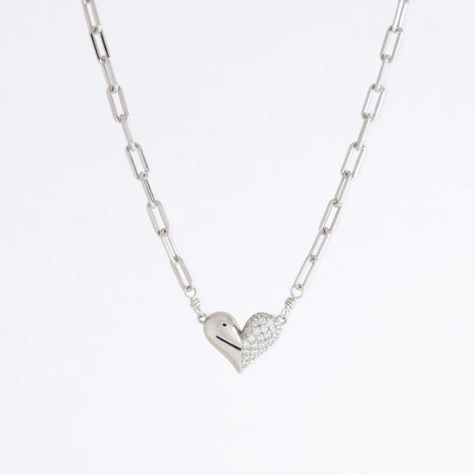 Silver heart-shaped pendant necklace on a light gray background
