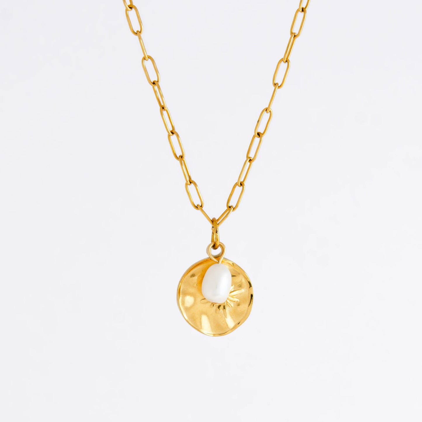 Gold paperclip necklace non-tarnish with a round sun pendant and a pearl on a light gray background