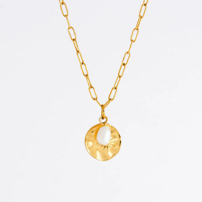 Gold paperclip necklace non-tarnish with a round sun pendant and a pearl on a light gray background