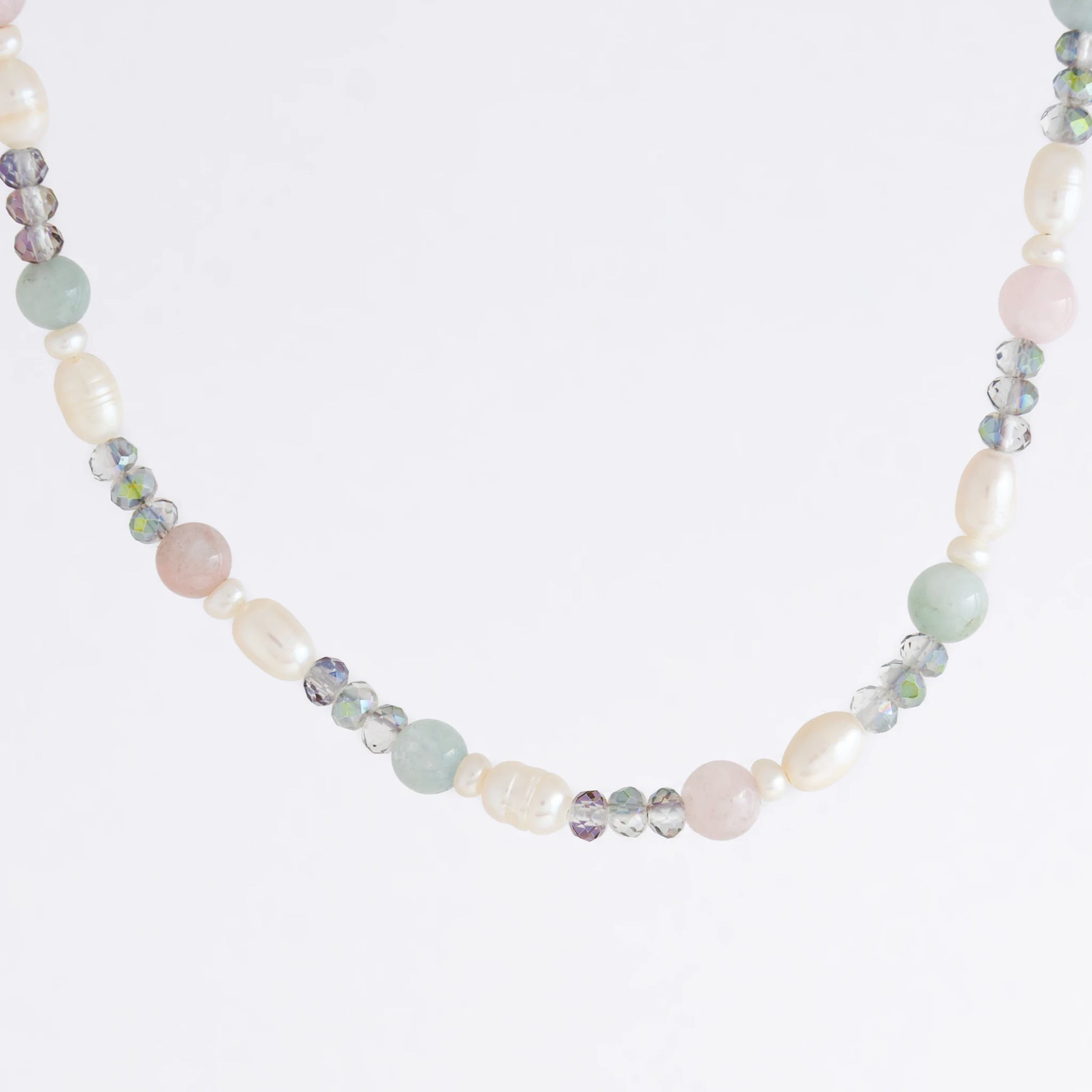 Beaded necklace with pearls and glass beads on a light gray background