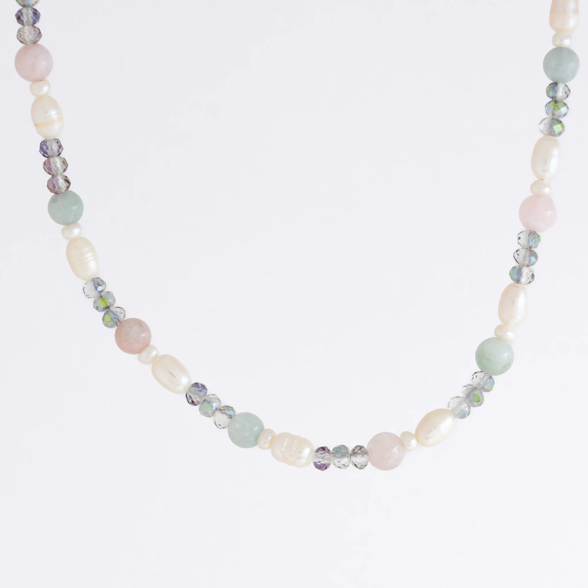 Beaded necklace with pearls and glass beads on a light gray background
