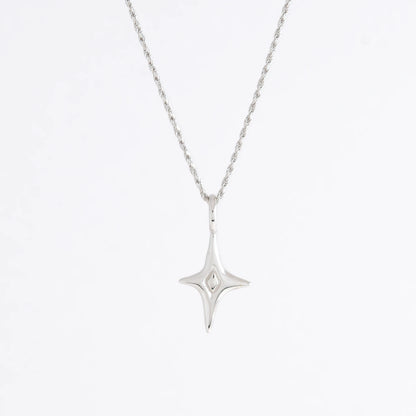 Silver star-shaped pendant necklace on a light gray background