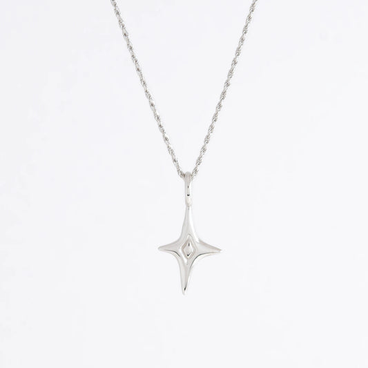 Silver star-shaped pendant necklace on a light gray background