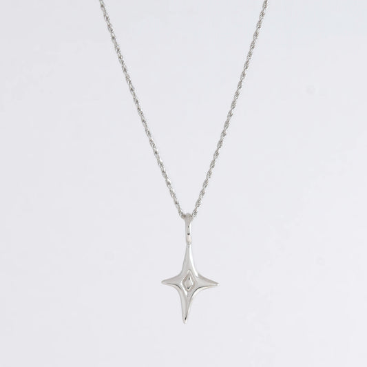 Silver star-shaped pendant necklace on a light gray background