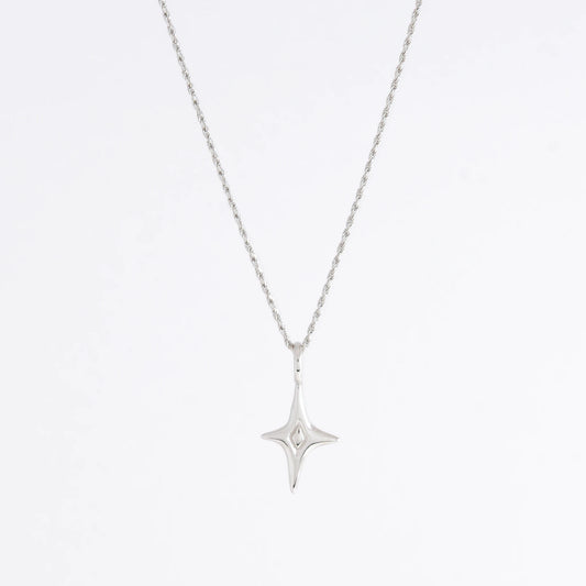 Silver star-shaped pendant necklace on a light gray background