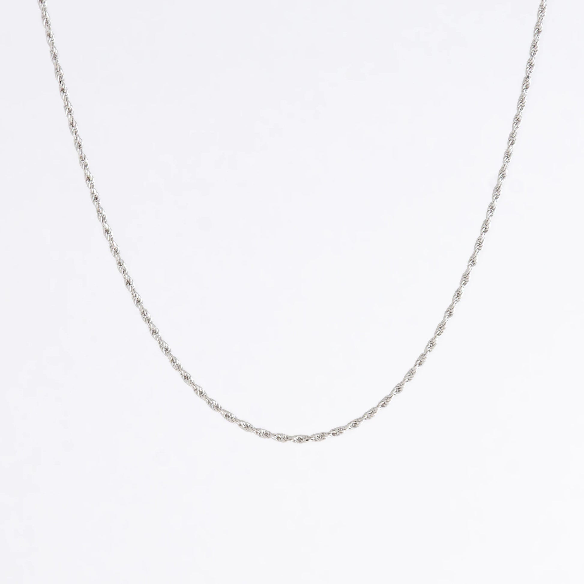 Sterling silver rope chain on a light gray background