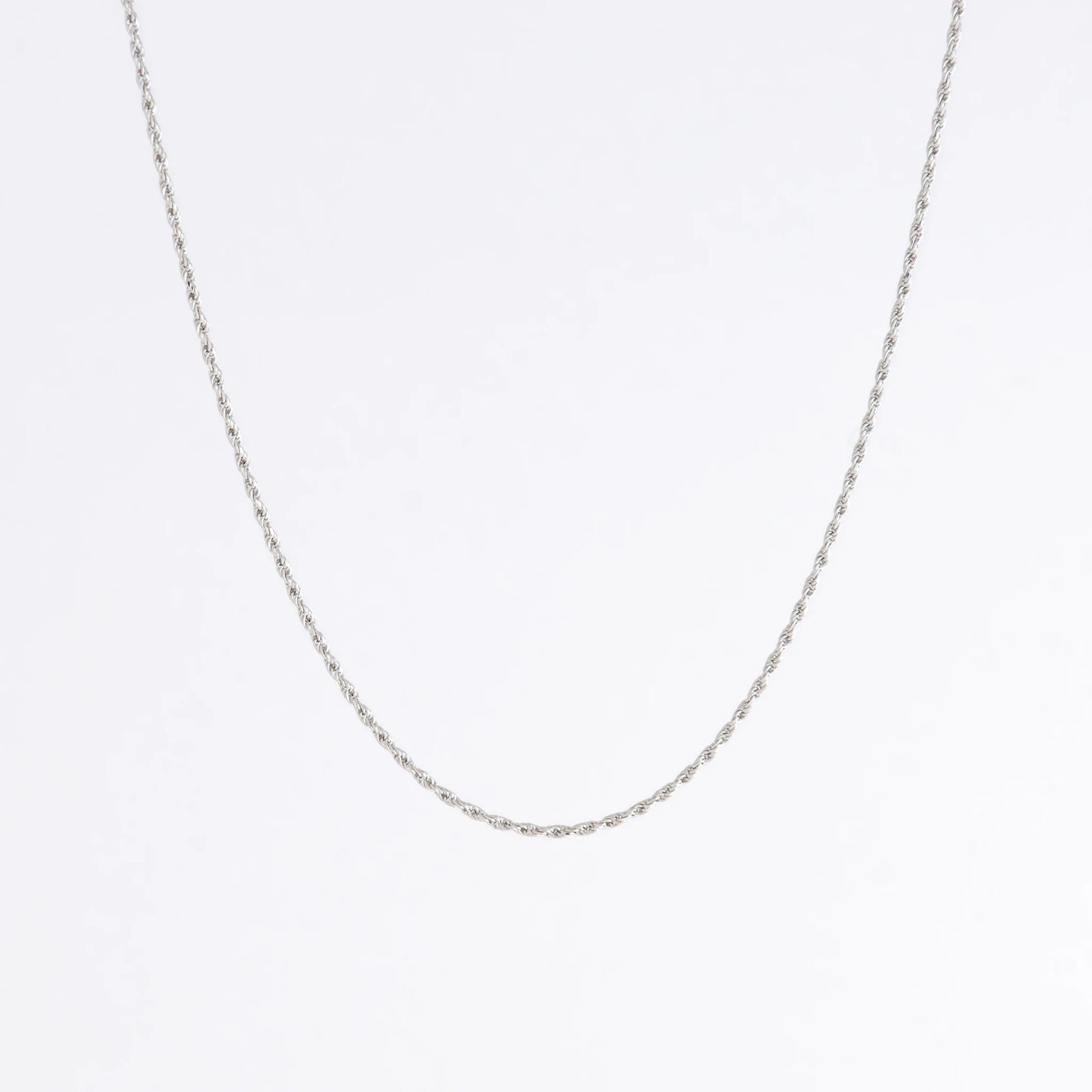Sterling silver rope chain on a light gray background