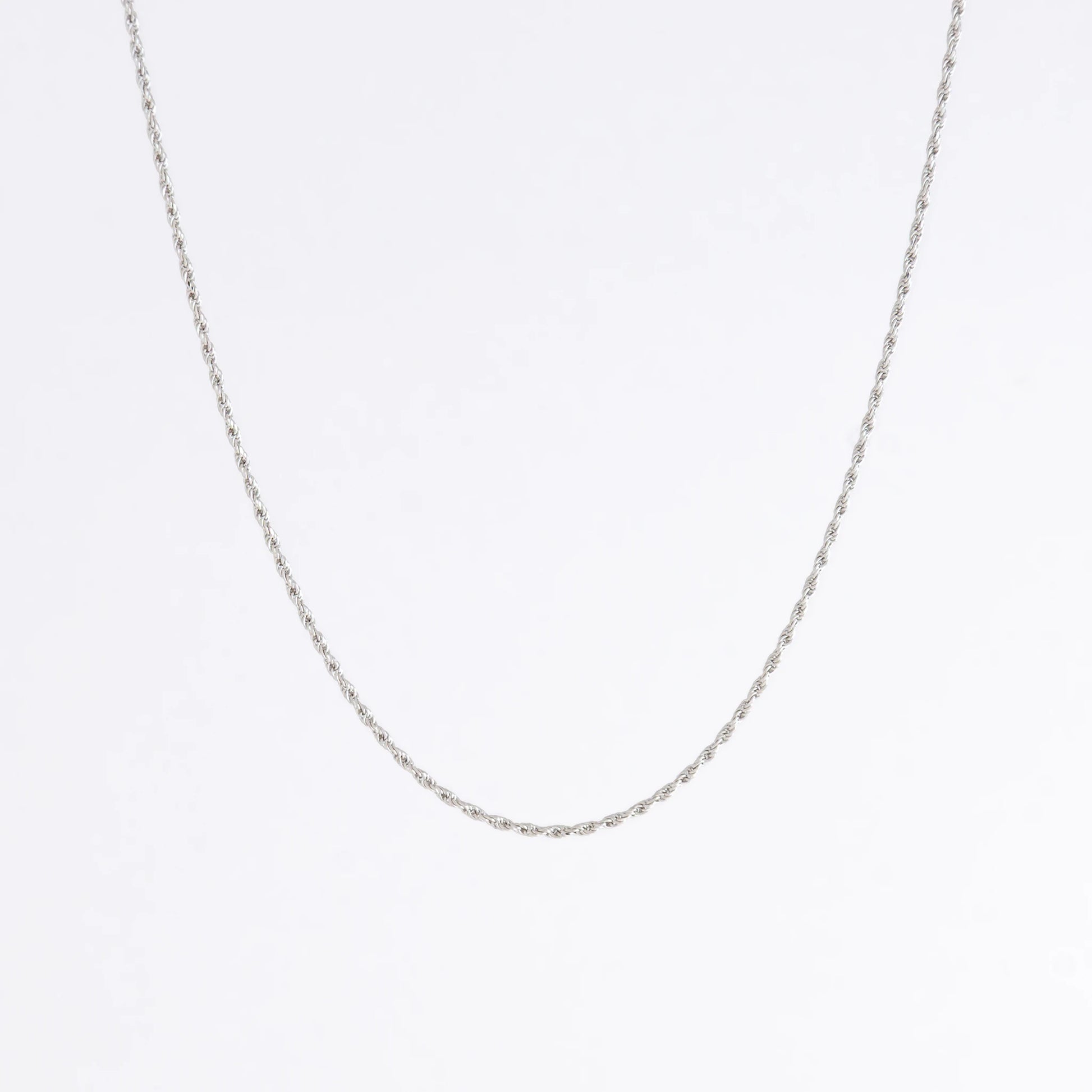 Sterling silver rope chain on a light gray background