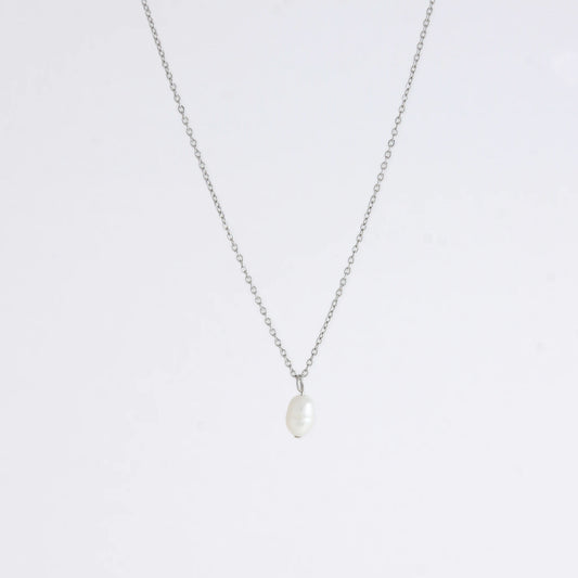 Silver dainty pearl necklace with freshwater pearl charm on a light gray background