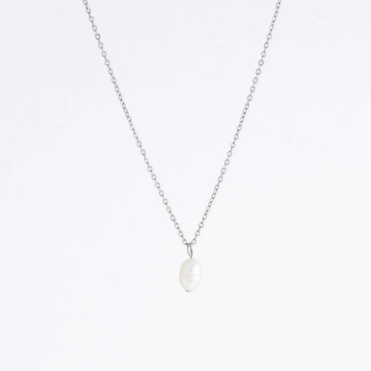 Silver dainty pearl necklace with freshwater pearl charm on a light gray background