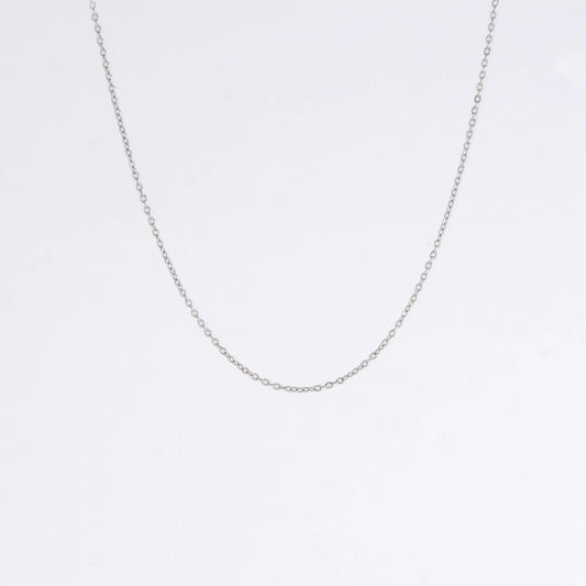 Silver stainless steel dainty chain necklace on a light gray background
