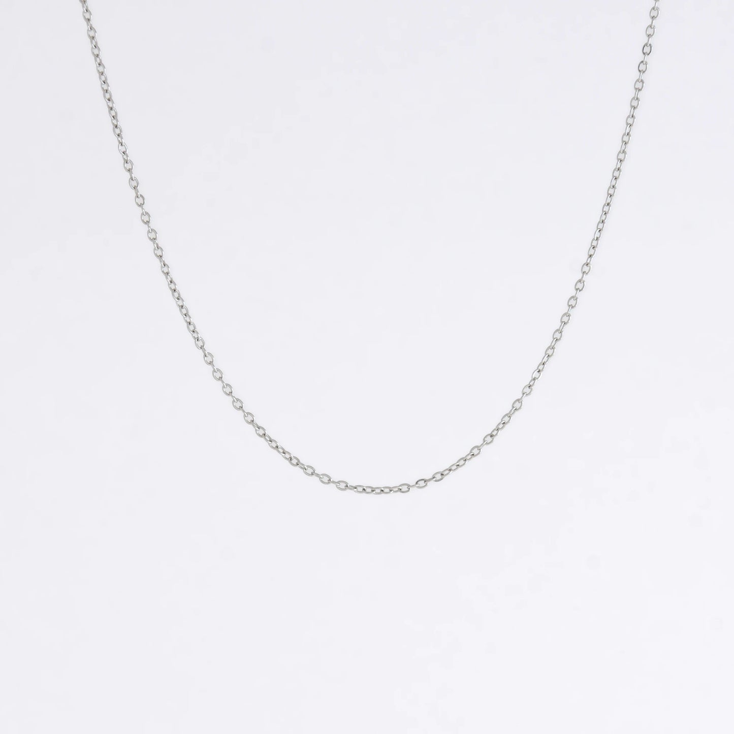 Silver stainless steel dainty chain necklace on a light gray background