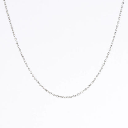 Silver stainless steel dainty chain necklace on a light gray background